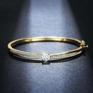 Elegant gold cross bracelet with a central round zircon and pavé detailing on dark base