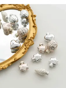 Detail of silver and champagne glass Christmas ornaments with heart and star shapes