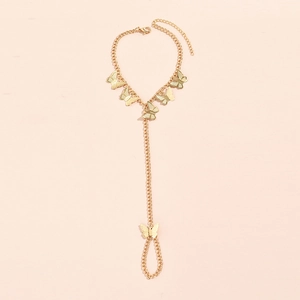 Detail shot of golden butterfly ring bracelet with sequins and multi-layer chain link