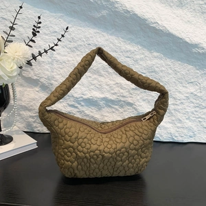 Army green quilted underarm bag with 3D floral texture and minimalist style