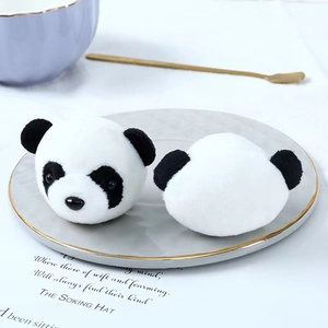 Close-up of plush panda head decorative accessories on a white plate with elegant props