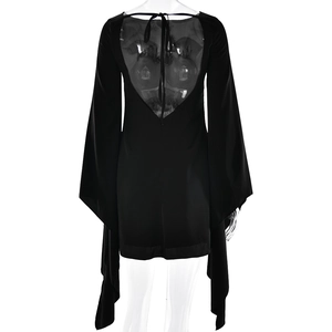 Detail of black velvet mini dress featuring an open back V-neck design with stylish ties