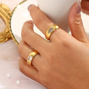 Detail of 18K gold plated stainless steel rings set with marquise and emerald cut zircons
