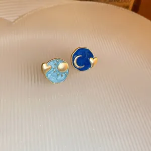 Asymmetric oil-painted sun and moon heart stud earrings with blue enamel and gold finish
