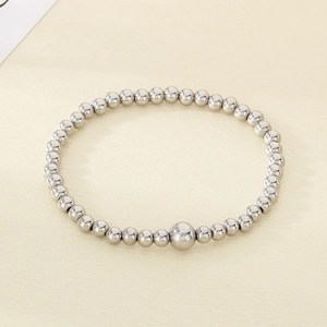 Macro shot of silver stainless steel bead bracelet with polished metal luster and center bead