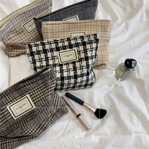 Plaid canvas makeup bags in assorted colors with Pleasant Time label on white fabric