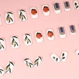 Press-on nail set with marble sand patterns and gold foil leaves on pink backdrop