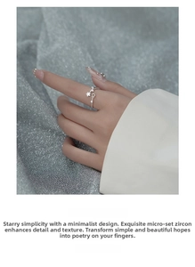 Close-up of star-shaped silver ring with zircon micro-pave detailing on a model's finger