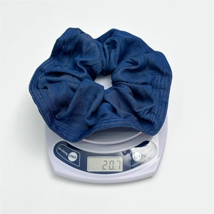Denim fabric scrunchie in blue weighing 20.7g displayed on a scale for weight verification