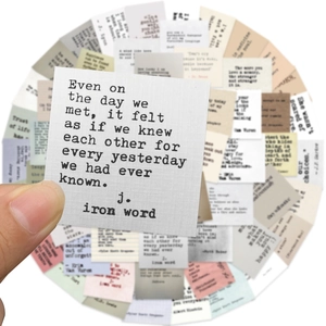 Detail of vintage typewriter font stickers with inspirational quotes on textured paper