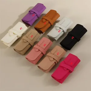 Nine colorful microfiber jewelry rolls for earrings, necklaces and watches with tie closure