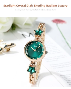Detail of gold bracelet watch featuring green star rhinestones and round emerald dial