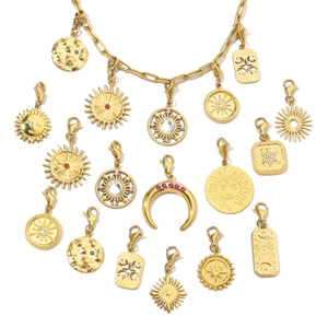 Close-up of gold stainless steel celestial pendants with colorful rhinestones on a chain