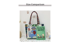 Size contrast of canvas tote bag with elephant print and ethnic straps next to a book