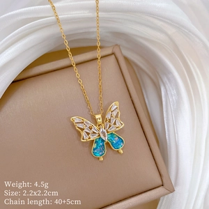 Close-up of golden butterfly pendant with blue marble inlay on brown jewelry box