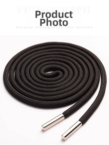 Macro shot of black woven drawstring with polished silver metal aglets for sportswear