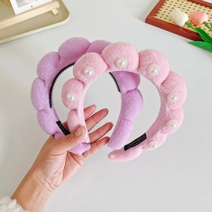 Plush padded bubble headbands in pink and purple with pearl accents and handmade labels