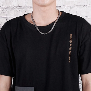 Men's silver punk Byzantine chain necklace shown on model against a white brick background