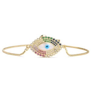 Macro shot of evil eye adjustable bracelet with colorful zircons and gold plated chain