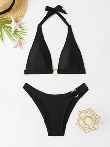 Close-up of black halter bikini with amber decorative rings and elegant palm leaf styling
