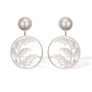 Detailed macro view of silver hollow round leaf earrings with a white pearl accent