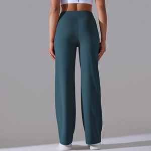 Macro detail of high-waisted teal wide-leg yoga pants showing soft fabric and loose fit