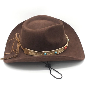 Detail of brown suede cowboy hat with turquoise beads, braided band and windproof cord