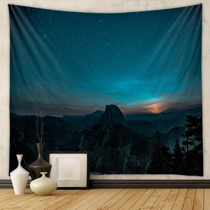Detail view of a galaxy tapestry with starlit mountain scenery in a cozy modern room