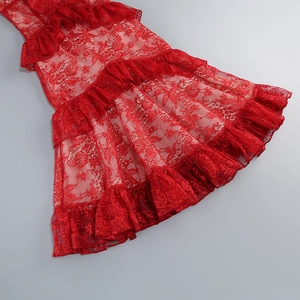 Detail of red lace ruffles and tiered pleats texture on a backless summer dress