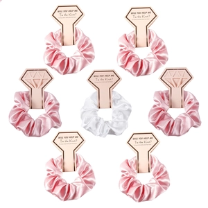 Detail of 7-piece satin hair scrunchies set with diamond ring cards for wedding favors