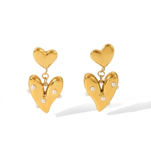 Detail of 18K gold-plated double heart earrings with white pearl accents and metallic texture