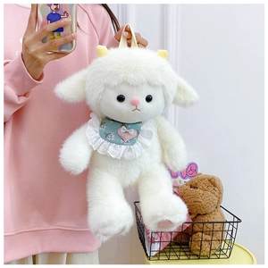 Detail of white plush sheep backpack with blue floral bib and pink heart embroidery