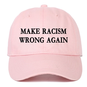 Close-up of pink cotton baseball cap with black Make Racism Wrong Again embroidery