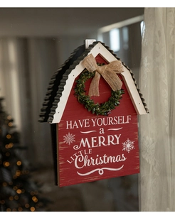 Red wooden house sign with evergreen wreath and burlap bow hanging on a glass window