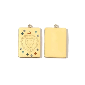 Detailed macro of 14K gold Aries pendant with colorful crystals and lion engraving