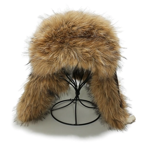 Detail view of plush faux fox fur lining on a brown winter earflap trapper hat