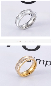 Detailed close-up of wide shell rings with sparkling pave crystals in gold and silver