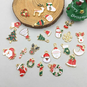 Flat lay of Christmas alloy charms featuring Santa, reindeer, and trees for DIY jewelry