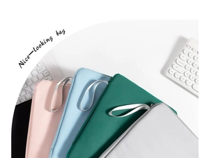 Flat lay of minimalist waterproof laptop sleeves in pink, blue, green, and grey colors