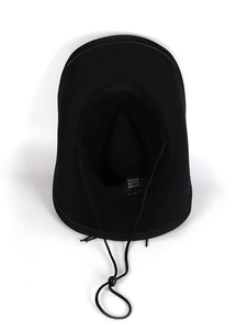Detail of black cowboy hat interior with 100% polyester label and adjustable wind strap