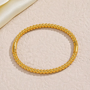 Polished gold beaded bangle for women in minimalist stainless steel with cylinder clasp