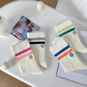 Close-up of ribbed cotton sports socks with colorful stripes and smiley face embroidery