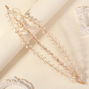 Detailed close-up of handmade bridal headband with gold leaves and white pearls