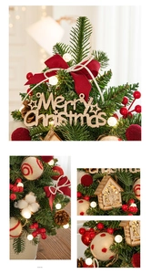Close-up of luxury mini Christmas tree with berries, pine cones and LED warm lights