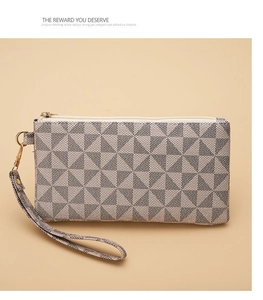 Macro shot of stylish geometric pattern and gold zipper detail on women clutch bag
