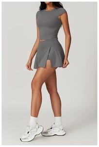 Dettaglio gonna sportiva grigio scuro con spacco laterale e pantaloncini integrati