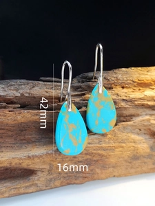 Detailed view of turquoise teardrop earrings with dimensions of 42mm by 16mm