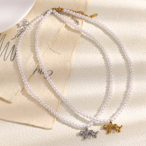 18K gold and silver plated hollow tiger pendant pearl necklaces for women on beige cloth