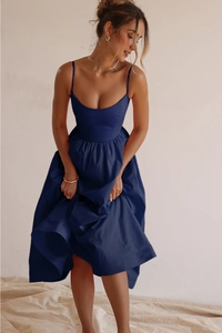 Detail of navy blue backless maxi dress with thin straps and flowing hemline