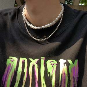 Double-layered necklace featuring white pearls and silver diamond tennis chain on a model